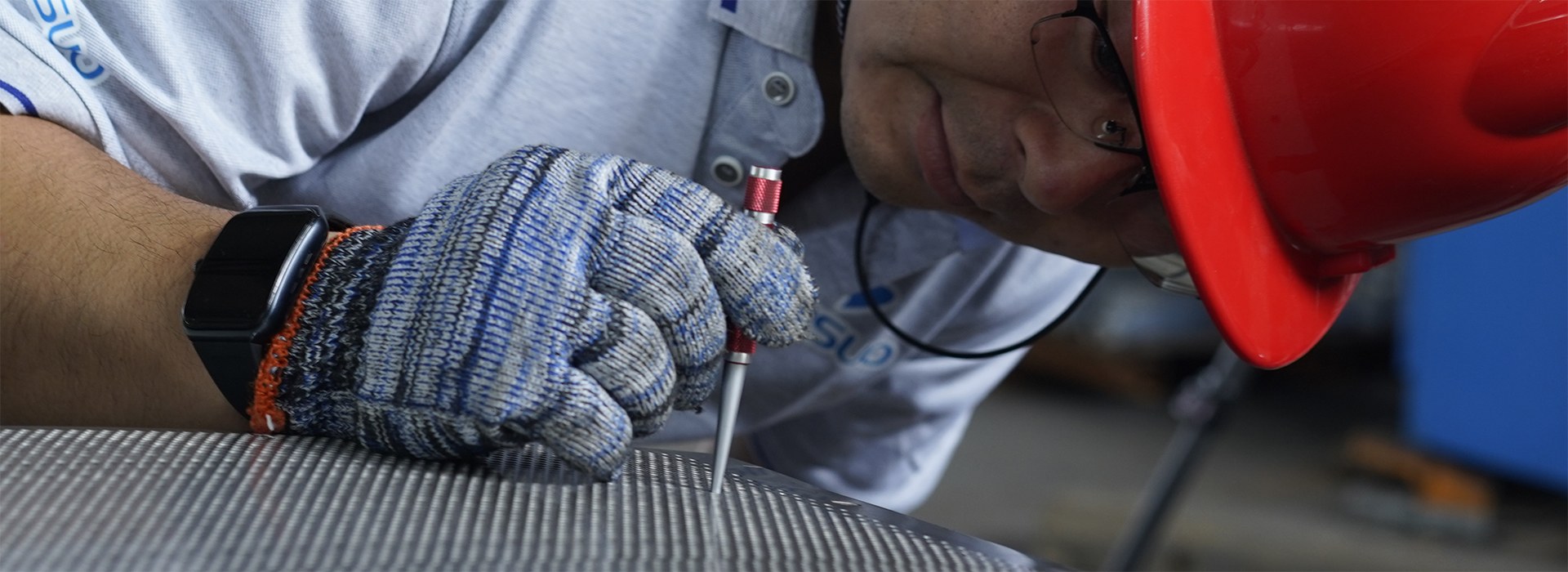 The staff is measuring the bore size of the perforated plate.